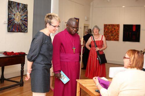 Museum Director Fiona Diaper and Archbishop of York Dr John Sentamu look on as Museum Volunteer Chris Cooke demonstrates in the Bailey Gallery.
